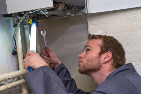plumber controlling the heating pipes