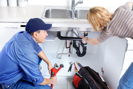 plumber repairing a sink professionally