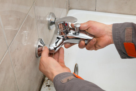 cheap technician hands fixing water tap
