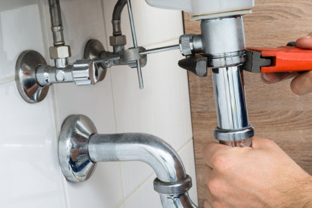 Best Plumber Fixing Sink with a tool