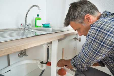 cheap professional plumber fixing sink pipe