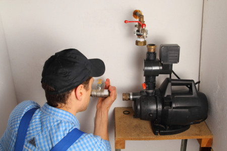 technician installing a water pump