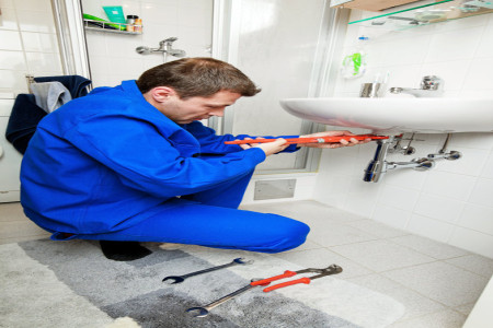 plumber repairing a broken sink