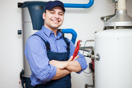 professional servicing a water heater