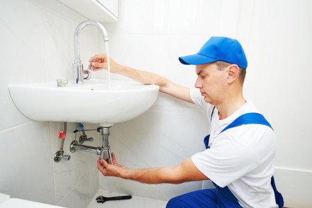 technician repair leaky faucet tap