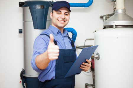 plumber servicing a hot-water heater at home