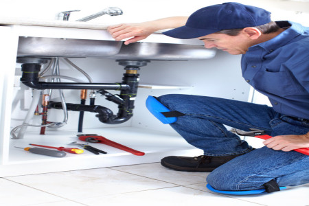plumber working fixing a kitchen sink