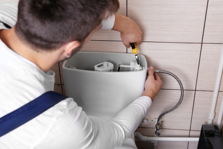 247 Plumber repairing toilet cistern at water closet