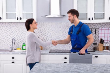 Plumber Shaking Hands With Client